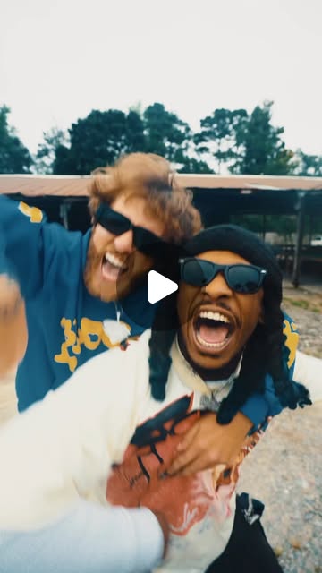 BlueBillz and Patrick Moss together outdoors, wearing sunglasses.