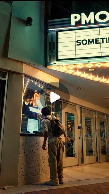Patrick outside a theater at night beneath the Sometimes marquee.